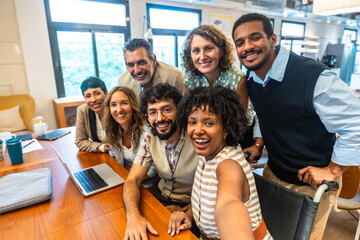 Diverse group of business colleagues taking a selfie in coworking office