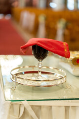 Decorative glass of wine served at a festive table during a celebration in a beautifully arranged venue