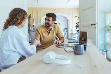 Business Meeting And Friendly Handshake In Bright Office With Laptop And Coffee