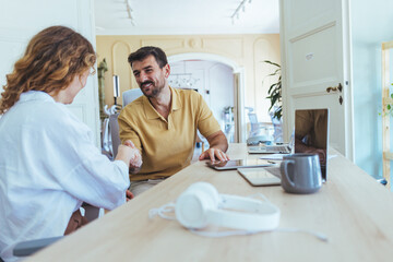 Casual Business Meeting With Handshake Between Colleagues At A Modern Office Desk