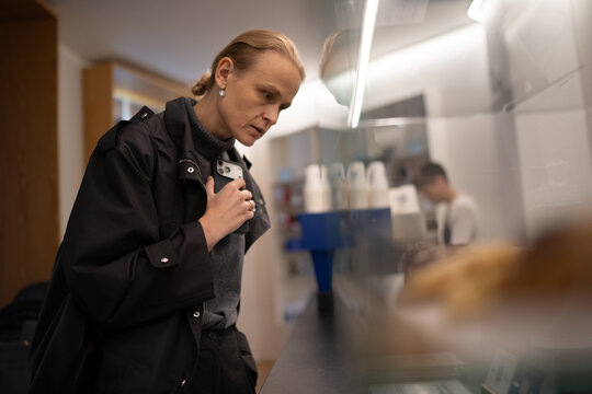 Woman looking at pastry display