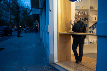 Woman drinking coffee in modern cafe