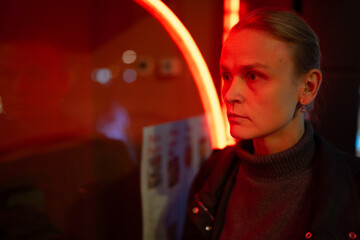 Woman in neon light reflection