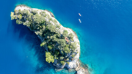 Stunning overhead view of rugged cliffs and crystal-clear Mediterranean water.
