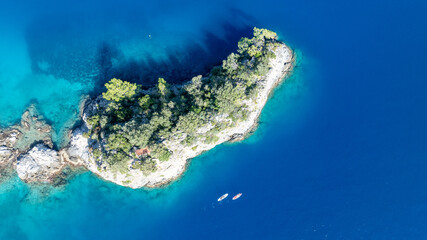 Stunning overhead view of rugged cliffs and crystal-clear Mediterranean water.