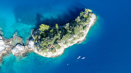 Stunning overhead view of rugged cliffs and crystal-clear Mediterranean water.