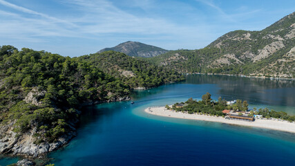 High-angle summer view of &Ouml;l&uuml;deniz with its curved beach and crystal-clear waters.