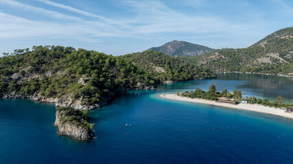 High-angle summer view of &Ouml;l&uuml;deniz with its curved beach and crystal-clear waters.