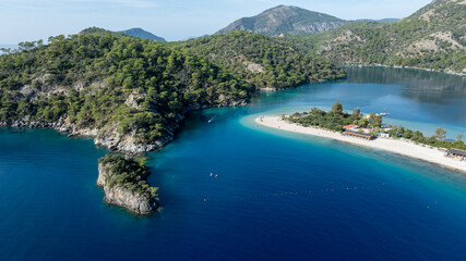 High-angle summer view of &Ouml;l&uuml;deniz with its curved beach and crystal-clear waters.