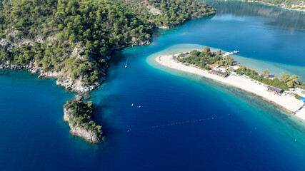 Scenic aerial footage capturing the bright blue lagoon and surrounding natural beauty.