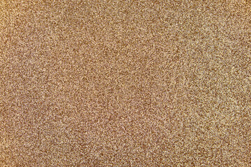 Shimmering gold glitter texture background with sparkling particles, creating a festive and luxurious decorative surface for holiday or celebration designs