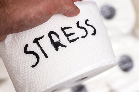 Hand holding a roll of toilet paper with the word Stress written on it, suggesting a humorous take on lifes pressures. A unique and engaging visual for relaxation concepts.
