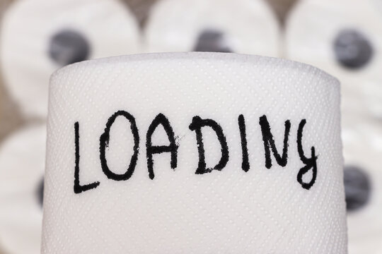 Handwritten word loading on a roll of toilet paper creates a humorous and ironic statement about everyday life. Ideal for marketing and social media contexts.
