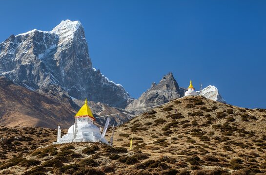 buddhist stupa with prayer flags near dingboche village