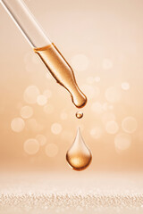 Glass dropper dispensing golden liquid drop, symbolizing skincare serum or oil. Bokeh background and sparkling surface, luxury and beauty