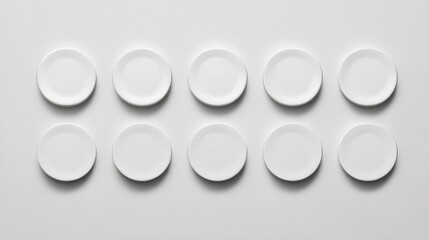 Ten identical white ceramic plates arranged neatly in perfect contact without gaps or overlap,