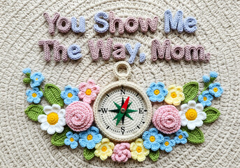Crochet compass surrounded by flowers, typography “You Show Me the Way, Mom”