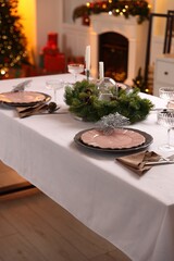 Festive table setting with Christmas decor indoors