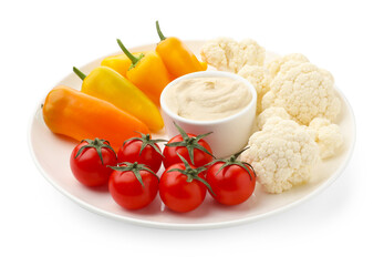 Different fresh vegetables and sauce isolated on white