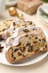 Slices of Stollen (traditional Christmas cake) served on white table, closeup