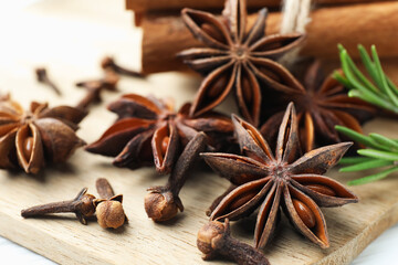 Mulled wine spices. Anise stars, cinnamon sticks, cloves and fresh rosemary on table, closeup