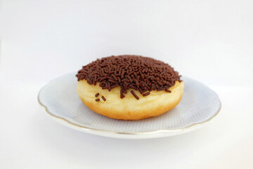 Donut with chocolate sprinkles on blue plate