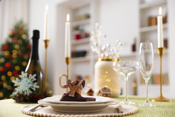 Festive table setting with Christmas decor and burning candles indoors, closeup