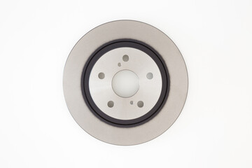 New brake disc isolated on light gray table background. Car spare part. Closeup. Top down view.