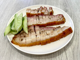 Crispy roasted pork belly on white plate