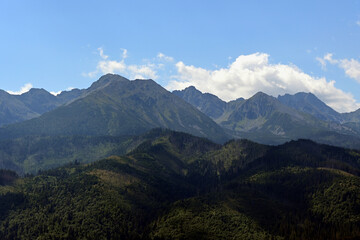 Fototapeta premium High Tatras seen from a metal observation tower with a modern glass terrace offering a stunning panorama at Poronin, Poland. Majestic mountains peaks of High Tatra moutnains.