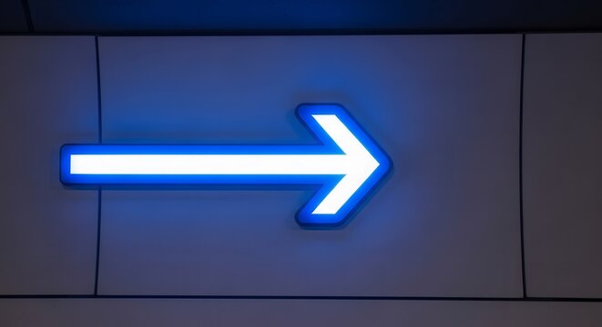 Neon Arrow Illuminated On Wall Directing the Right and Signaling Guidance For The Future