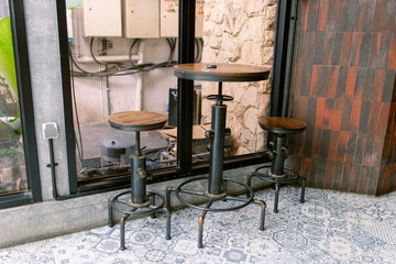 Intimate bistro setting with rustic industrial bar stools and table perfect for cozy conversations and trendy cafe concepts, capturing urban charm and relaxed vibe