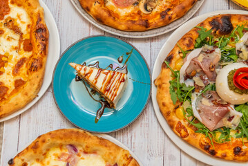 A smoked salmon and dill pizza covers a base of crème fraîche with thin slices of salmon and chopped dill.