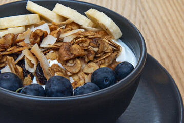 The scene conveys healthy indulgence with apple slices, purple grapes, and almonds drizzled with a ribbon of liquid caramel atop cottage cheese