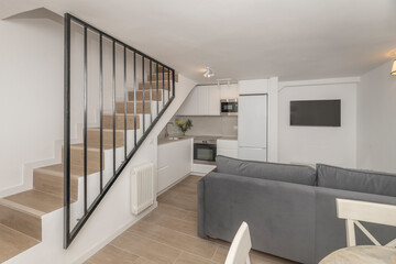 A photograph of a Nordic-rustic style living room with a white fireplace, a gray linen sofa, and pine coffee tables with visible knots.