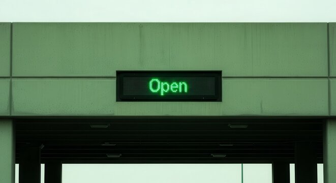 Open Sign Illuminated Against Building Facade Signaling Availability and Public Access
