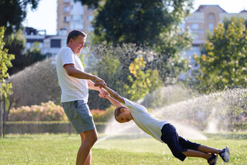 Father and Son Enjoying Playful Day in a Sunny Park Setting