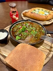 Georgian kharcho soup and a ceramic figurine of a Georgian