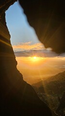 sunrise through a burned out hole in a tree