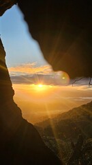 sunrise through a burned out hole in a tree
