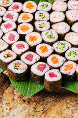 Colorful sushi rolls arranged neatly on a bamboo mat with vibrant ingredients