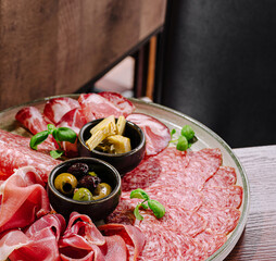 Delicious charcuterie platter with assorted meats and olives served elegantly