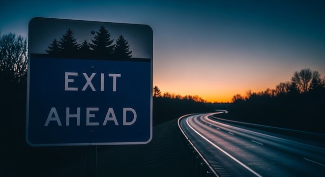 Roadside Sign Indicating Exit Ahead at Twilight with a Scenic Sunset View
