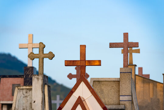 tombstone crosses against blue sky