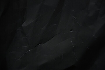 Black crumpled paper texture background. A wrinkled and creased blank paper texture, perfect for grunge backdrop design.