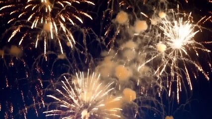 Golden fireworks explode across the dark night sky, filling the scene with radiant light and dynamic bursts that capture the excitement and celebration of the New Year.