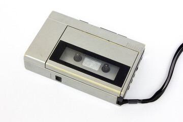 Obraz premium Gray analog cassette tape audio player and recorder, isolated on white. An old-fashioned technology for enjoying good music.