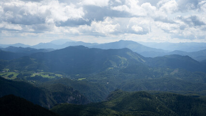 Scenic mountainous landscape with green hills blue sky and curly clouds on a sunny summer day