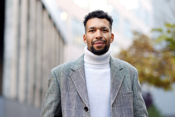 Portrait of handsome man in suit on city street