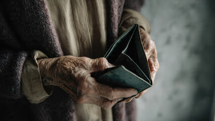 Elderly, wrinkled hands grasp an empty, worn wallet, symbolizing financial hardship, poverty, and economic vulnerability. A poignant depiction of senior struggle.